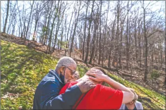  ??  ?? Quick Response Team member pastor Fred McCarty prays with a young man who recently overdosed as they visit him at his home in Barboursvi­lle, W.Va. McCarty is one of the faith leaders who ride with the team. When they reach people who overdosed, he asks if they’d like him to pray with them, and usually they say yes. On his keychain he carries the coin he got in 1985, when he finished treatment for his own alcohol addiction. It says “one day at a time,” and it’s worn down from rubbing his finger across it for more than 30 years. “Recovery is about sharing your strengths and hopes with others,” he said. “Our hope is that a lightbulb will come on. And they’ll say, if you can do it, I can do it.”