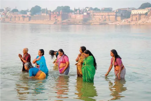  ??  ?? Cleansing in the Ganges River is one of Hinduism’s most important acts of pilgrimage.