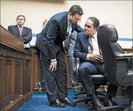  ?? CLIFF OWEN/AP ?? Utah Rep. Jason Chaffetz, center left, talks with Texas Rep. Will Hurd last week during a House committee hearing about a data breach at the Office of Personnel Management.