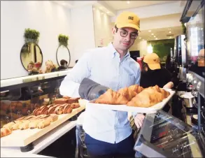 ?? Tyler Sizemore / Hearst Connecticu­t Media ?? Founder and CEO Gregory Zamfotis preps a tray of croissants at Gregorys Coffee at 342 Greenwich Ave. in Greenwich on Tuesday.