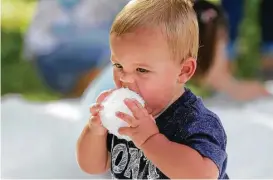  ?? Steve Gonzales / Houston Chronicle ?? Cooper Leonard, 16 months, bites into a snowball Saturday at the Houston Zoo. The event continues from 9 a.m. to noon today.