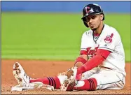  ?? AP/DAVID DERMER ?? Cleveland Indians’ Francisco Lindor sits near second base after being forced out in a double play in the seventh inning Friday night against the Kansas City Royals in Cleveland. The Royals won 4-3, ending the Indians’ winning streak at 22 games.