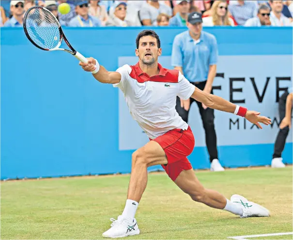  ??  ?? Final in sight: Novak Djokovic stretches for a point on the way to beating Jeremy Chardy 7-6, 6-4 in the semi-final at Queen’s Club yesterday, setting up a date with Marin Cilic today