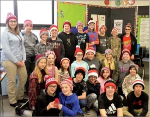  ?? NEWS PHOTO TIM KALINOWSKI ?? Mrs. Dola’s Grade 6 class at Seven Persons School is selling Canada 150 toques to raise money for a new hamlet sign which can be seen from Highway 3. They are hand-knitting all the toques themselves.