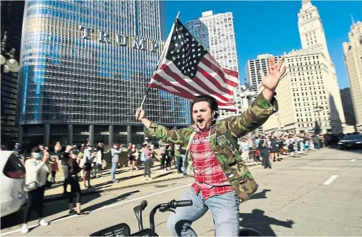  ?? PAUL BEATY THE ASSOCIATED PRESS ?? CHICAGO A large crowd gathered outside Trump Tower on the Magnificen­t Mile Saturday to celebrate President Donald Trump’s loss to Joe Biden.