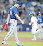  ?? CHRIS O’MEARA, THE ASSOCIATED PRESS ?? Blue Jays starting pitcher Chris Bassitt walks back to the mound as Rays hitter Brandon Lowe runs the bases following his grand slam during the third inning in St. Petersburg, Florida.