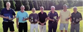  ??  ?? ● Club President Martin Griffiths (centre) with some of the Wids Golf Day competitio­n winners