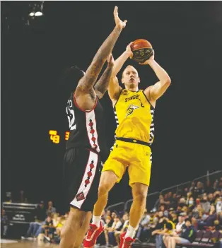  ?? IAN KUCERAK ?? Jordan Baker of the Stingers goes up for the shot while under pressure from Nicholas Ward of the Ottawa Blackjacks during CEBL playoff action Friday night at Edmonton Expo Centre.