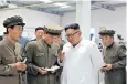  ??  ?? Kim ensures he is seen to admonish staff at a machine factory in Hamgyong province