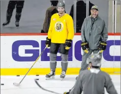  ??  ?? Golden Knights coach Pete Deboer and forward Dylan Sikura watch drills on the opening day of training camp at City National Arena.