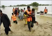  ?? ASIM TANVEER — THE ASSOCIATED PRESS ?? Army troops evacuate people from a flood-hit area in Rajanpur, district of Punjab, Pakistan, on Saturday. Officials say flash floods triggered by heavy monsoon rains across much of Pakistan have killed nearly 1,000 people and displaced thousands more since mid-june.