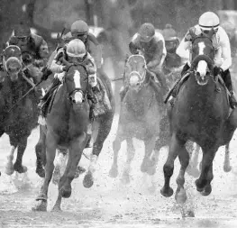  ?? ANDY LYONS/GETTY IMAGES ?? Justify (right) carried jockey Mike Smith to a mighty win in Saturday’s Kentucky Derby.