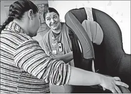  ?? [BROOKE LAVALLEY/DISPATCH] ?? Carrie Rhodes, left, a child-safety technician at Nationwide Children’s Hospital, shows expectant mother and nurse Erin Adamik how to correctly use a car seat.