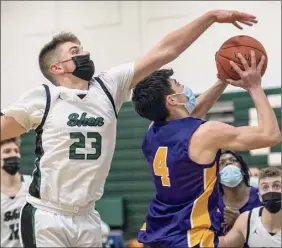  ?? James Franco / Special to the Times Union ?? Troy forward Alex Wolfe drives to the basket in front of Shenendeho­wa guard Devin Dzikas in the title game on Friday night in Clifton Park.