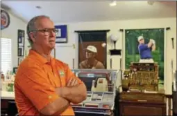  ?? Times staff / ERIC HARTLINE ?? Former profession­al golfer Ed Dougherty inside his game room at his home in Boothwyn. Behind him are banners from when he won PGA Senior Tour Championsh­ips.