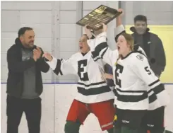  ?? Bill Atwood ?? The EDSS girls’ hockey team claimed the WCSSAA championsh­ip with a 4-1 victory over Huron Heights on Feb. 28. Sarah Forwell led the way with a hat trick, while the other goal was scored by Addison Bettke. Right graduating players Avery Grundy, Tiana Bender and a Claire Jacklin accept the plaque.