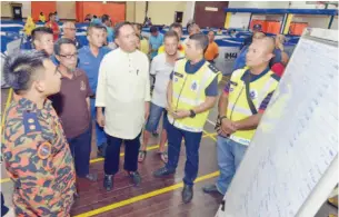  ??  ?? SAPAWI mendengar taklimat oleh Matlin di pusat pemindaan banjir Dewan Serbaguna Sipitang.