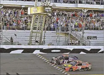  ??  ?? Denny Hamlin celebrates after holding off Martin Truex Jr. to win Daytona 500 by 0.010 seconds.