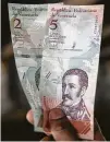  ?? Carlos Becerra / Bloomberg ?? The new bolivar banknotes have five fewer zeros.