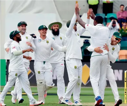  ?? AFP ?? South Africa paceman Kagiso Rabada (2nd from right) celebrates his wicket of Australia’s batsman Callum Ferguson with teammates in Hobart —