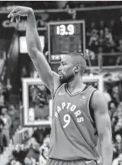  ?? Rob Carr / Getty Images ?? Toronto’s Serge Ibaka sank a 3-point shot with 15 seconds left in double overtime to help the Raptors hold off the Wizards and secure a fifth straight win.