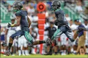  ?? GREG LOVETT / THE PALM BEACH POST ?? Atlantic’s DeAndre McCray (left) leads the way for Javone Jackson en route to a touchdown against Dwyer on Friday in Delray Beach.