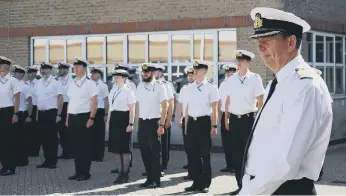  ?? ?? Captain Voyce, right, says farewell to staff within the Royal Naval Air Engineerin­g and Survival Equipment School.