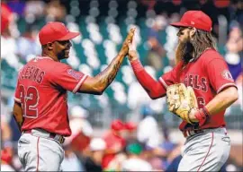  ?? Butch Dill Associated Press ?? ANGELS RELIEVER Raisel Iglesias celebrates with Brandon Marsh after they defeated the Braves in Atlanta on Sunday to end a five-game losing streak.