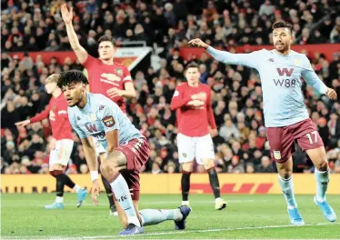  ?? REUTERS ?? ASTON Villa’s Tyrone Mings, left, celebrates scoring their equaliser to earn a 2-2 Premier League draw with Manchester United at Old Trafford yesterday. In last night’s other match, high-flying Leicester City went second with a 2-1 home win against Everton. |