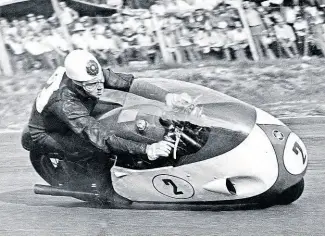  ?? Mortons’ Motorcycle Archive photo. ?? The epitome of style is demonstrat­ed by Geoff Duke as he heels over a fully-faired 500cc Gilera four in 1957. Born in St Helens, Lancashire, he was declared the first rider to lap the TT course at 100mph in 1955, but later the speed was corrected to 99.97mph. Injuries prevented him from riding the Gileras in the historic 1957 TT, so it was Scot Bob McIntyre who became the first to crack the ‘ton’ barrier several times over.