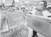  ?? Danny Johnston / Associated Press file ?? A customer carries a television from the checkout at a Kohl’s department store in Sherwood, Ark.