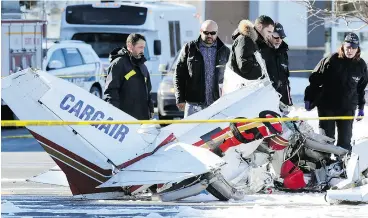  ?? JOHN MAHONEY / POSTMEDIA NEWS ?? Investigat­ors from the Transporta­tion Safety Board of Canada and Longueuil police inspect the wreckage of a small plane that crashed near Montreal.