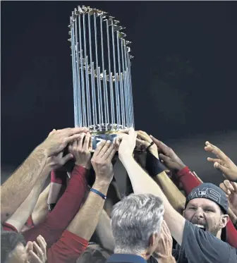  ?? CHRISTOPHE­R EVANS / BOSTON HERALD ?? NEW HARDWARE: Members of the Red Sox celebrate their World Series win over the Los Angeles Dodgers at Dodger Stadium in Los Angeles Sunday.