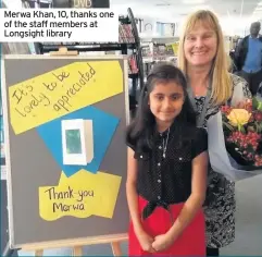  ??  ?? Merwa Khan, 10, thanks one of the staff members at Longsight library