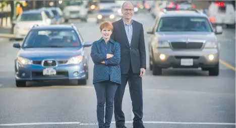  ?? ARLEN REDEKOP ?? Mobility Pricing Commission vice-chair Joy MacPhail and chair Allan Seckel stand in front of traffic on West Broadway in Vancouver on Monday. The commission will today release its Phase 1 Project Update Report, which contains research on Metro...