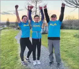  ??  ?? CHALLENGE COMPLETED - Rachel and Dillon Lynch pictured with Pat O’Brien at sunset in Kildorrery village after completing their mammoth fundraiser, ‘Walk All Day Within our 5K’ in aid of Barretstow­n.