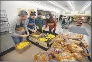  ?? Clay Adams NWA Democrat-Gazette/J.T. Wampler ?? Volunteers (from left) of Bentonvill­e, his wife Kate Adams and their children Fletcher Adams, 13, and Olivia Adams, 16, sort squash Wednesday at Feed Rogers, a food pantry operated by the Northwest Arkansas Food Bank. It’s set up like a grocery store, letting people choose items they need. Feed Rogers is located at 216 S. 13th St. in Rogers.