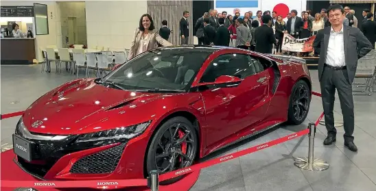  ?? ROB MAETZIG/STUFF ?? Honda NZ managing director Nobuya Sonoda and general manager of marketing Nadine Bell pose with a Honda NSX at the company’s Honda HQ.