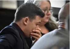  ?? Tribune News Service/getty Images ?? Kyle Rittenhous­e puts his hand over his face as he is found not guilty on all counts at the Kenosha County Courthouse on Friday in Kenosha, Wisconsin.