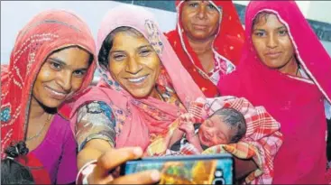  ?? PTI ?? A woman takes a selfie with her newborn child in Rajasthan on Saturday. As the child was born at 12.02 am when the government was launching the new tax regime, the mother plans to name the child GST.