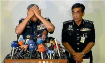  ?? PHOTO: REUTERS ?? Malaysian police chief Khalid Abu Bakar demonstrat­es how Kim Jong-nam was killed, during a news conference in Kuala Lumpur yesterday.