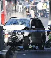  ?? JOE CASTRO / AAP IMAGE VIA AP ?? A damaged vehicle is seen on Flinders Street, in Melbourne Thursday, after a car drove into pedestrian­s on a sidewalk in the Australian city.