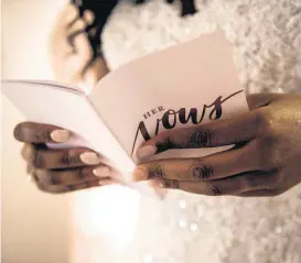  ??  ?? Destiny Gonzaque Washington reads over her wedding vows before her nuptials at The Manor at Coffee Creek in Edmond.