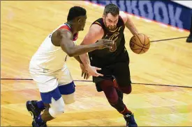  ?? ASSOCIATED PRESS ?? Cavaliers forward Kevin Love, returning from a calf injury, dribbles around Pelicans forward Zion Williamson on Friday night in New Orleans. Love played 10 minutes and scored four points.