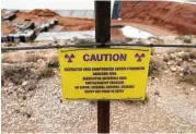  ?? Kin Man Hui / San Antonio Express-News ?? A caution sign is posted at the low-level radioactiv­e waste site at Waste Control Specialist­s near Andrews.