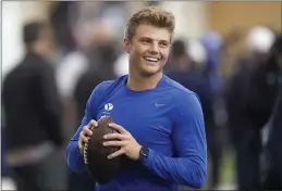  ?? RICK BOWMER — THE ASSOCIATED PRESS ?? BYU quarterbac­k Zach Wilson warms up before participat­ing in the school’s pro day workout for NFL scouts on Friday in Provo, Utah.