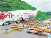  ?? ANI ?? ■ Officials inspect the wreckage of the Air India Express flight at the Kozhikode Internatio­nal Airport on August 8.