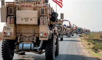  ?? AP ?? A US military convoy drives near the town of Qamishli, north Syria, likely headed to the oilrich Deir el-Zour area.