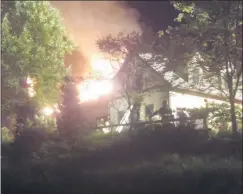  ?? KENNETH DICKINSON— ASSOCIATED PRESS ?? In this Sunday, Aug. 9, 2020 photo, a massive fire engulfs the home of cooking show star Rachael Ray, in Lake Luzerne, NY. Ray’s