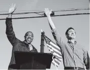 ?? BRYNN ANDERSON AP file | Nov. 15 ?? Georgia Democratic candidates for U.S. Senate Raphael Warnock, left, and Jon Ossoff wave at a Marietta, Ga., rally